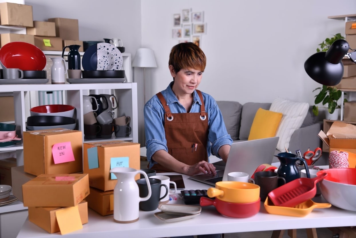 Small business owner using a laptop to research cash flow strategies.